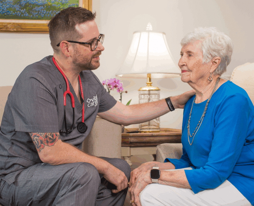 Healthcare professional providing compassionate care to elderly woman in a home setting.