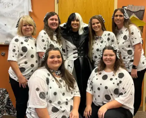 Group of staff members dressed as Dalmatian dogs at VitalCaring event.