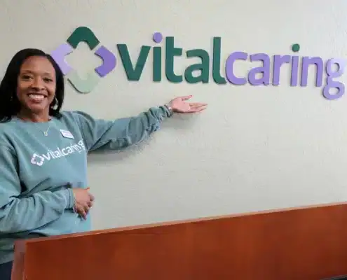 VitalCaring team member welcoming visitors at the reception area.