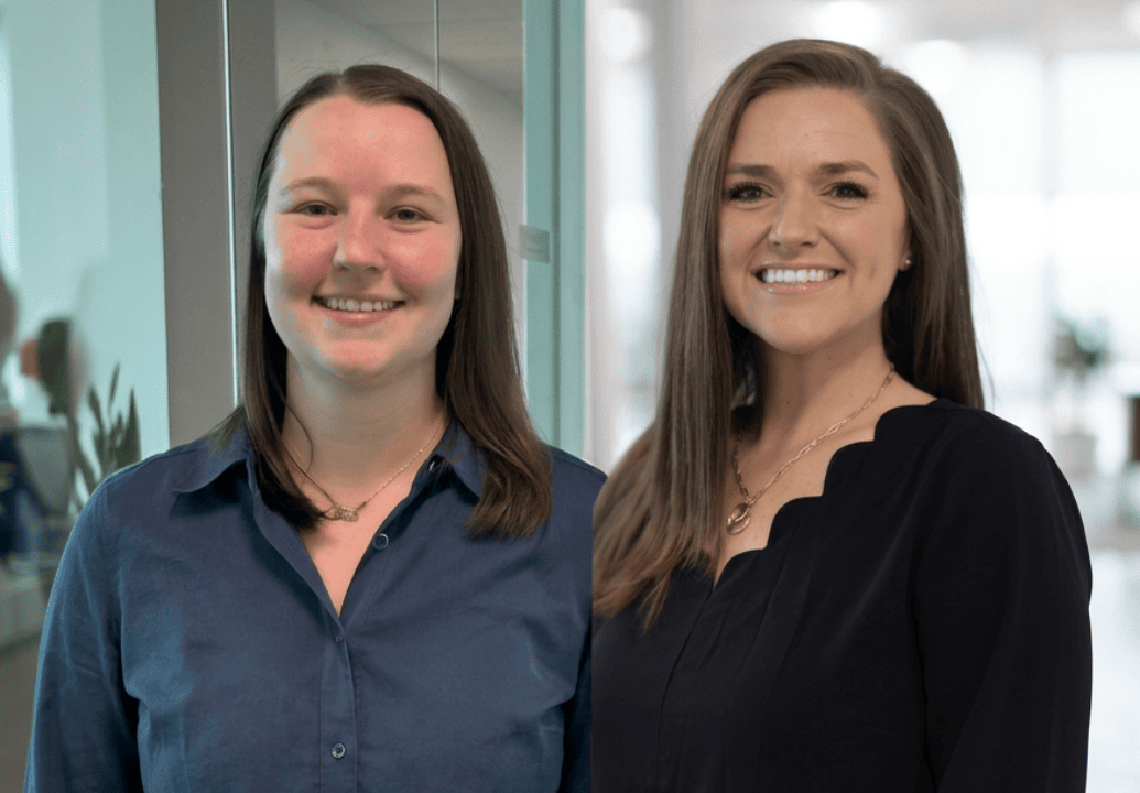 VitalCaring team members smiling in a professional office environment, showcasing compassionate heal.