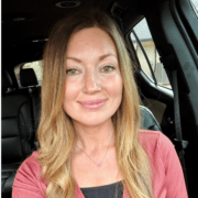 Smiling woman in car representing VitalCaring team member.