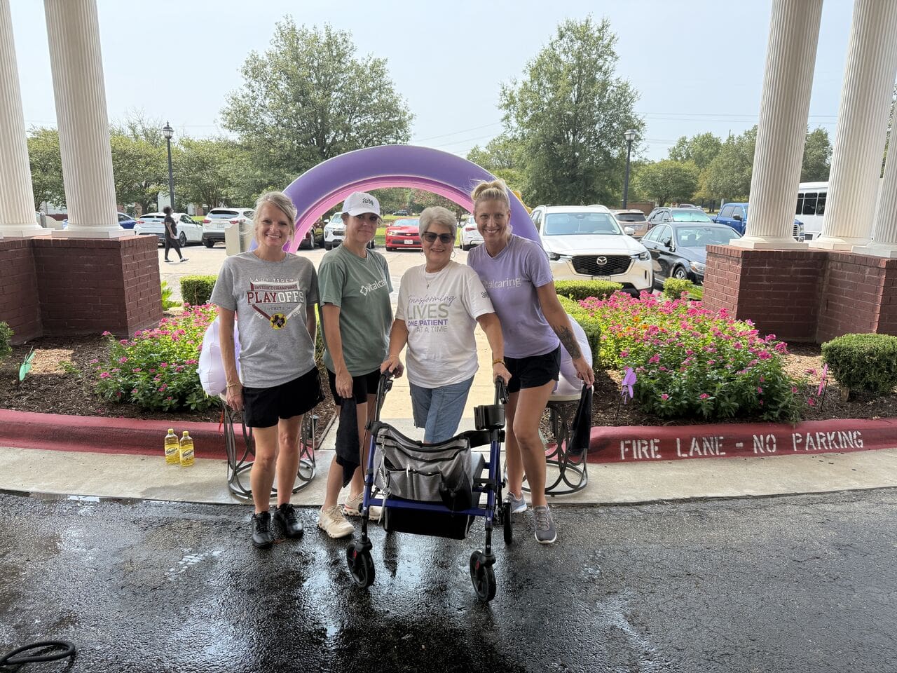 Group of four women with a wheelchair at a community event.