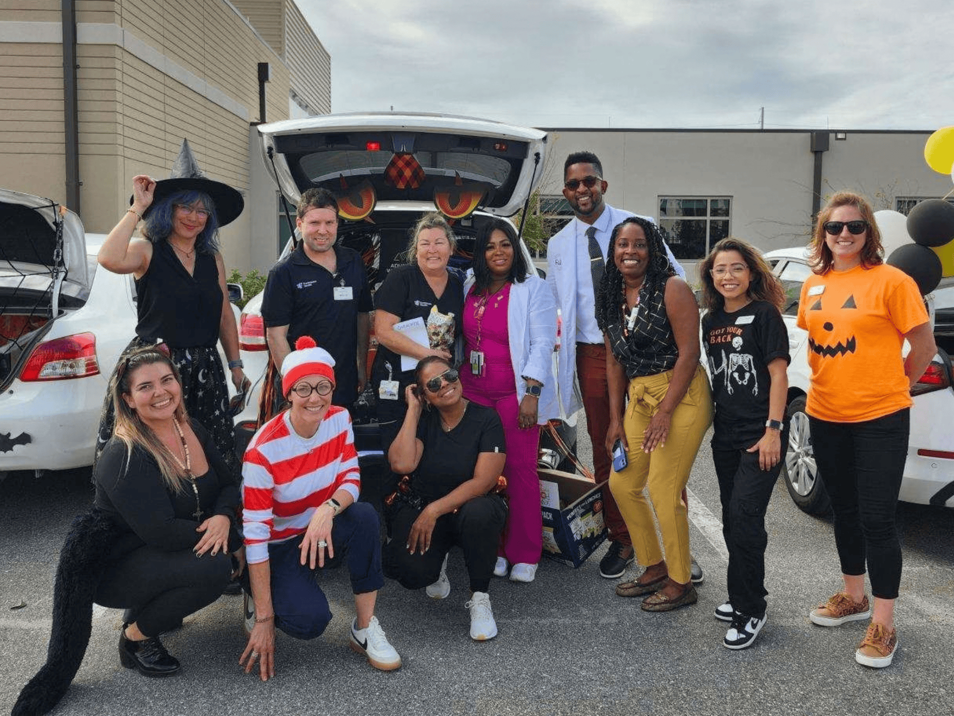 Group of people in Halloween costumes at VitalCaring event.
